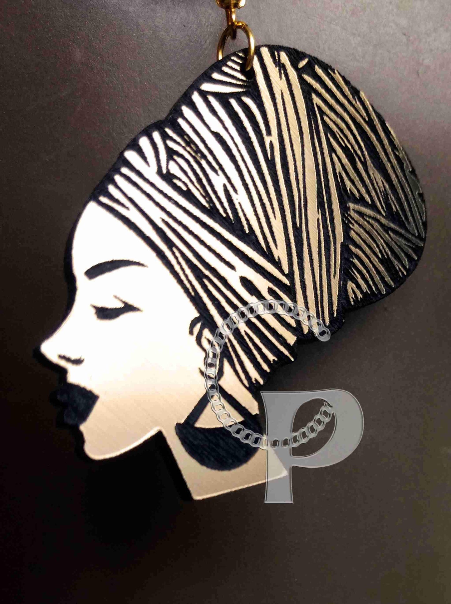 African earrings woman head wrap silhouette metallic look gold and black